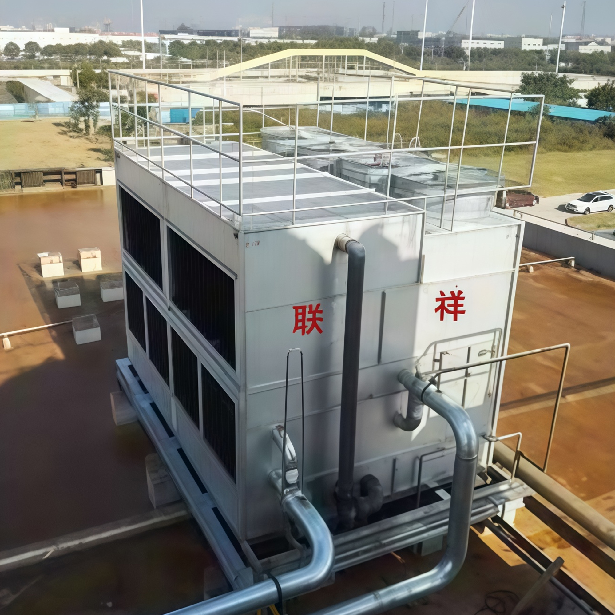Square closed cooling tower with piping connections installed on a rooftop
